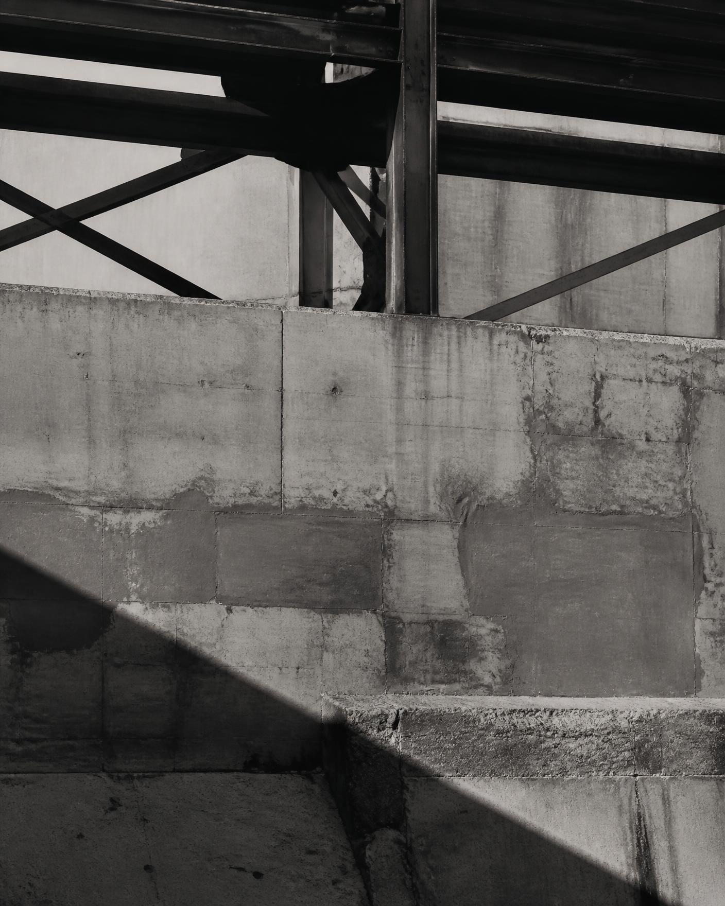 Concrete and steel structure in Detroit cast in hard afternoon shadow